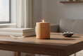 Load image into Gallery viewer, A lit wood-grain ceramic candle vessel resting on a wooden table in soft daylight, creating a peaceful and comforting atmosphere.